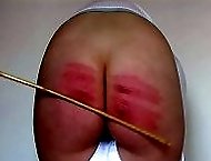 Searing caning on her gorgeous big ass - white panties - red stripes - purple bruises